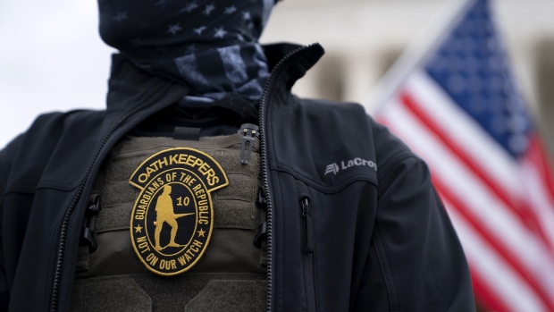 A demonstrator wears an Oath Keepers anti-government organization badge on a protective vest during a protest outside the Supreme Court in Washington, D.C., U.S., on Tuesday, Jan. 5, 2021. Republican lawmakers in Washington are fracturing over President Trump's futile effort to persuade Congress to overturn his re-election defeat, as his allies spar with conservatives who say the Constitution doesn't give them the power to override voters.