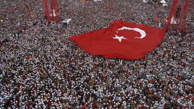 Crowds hold a huge Turkish national flag as Muharrem Ince, presidential candidate backed by the Secular Republican People's Party (CHP), speaks during his last pre-election campaign rally in Maltepe, Istanbul, Turkey, on Saturday, June 23, 2018. Ince, a 54-year-old former physics teacher, addressed what his CHP party claimed was a crowd of 4 million in the Maltepe district on the Asian side of the Bosporus.
