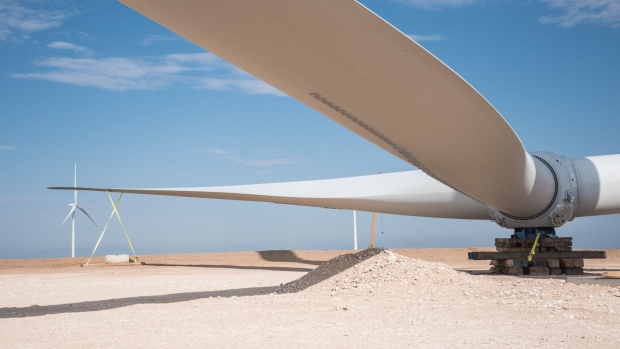Rotor blades sit on the ground next to a wind turbine under construction at the Avangrid Renewables La Joya wind farm in Encino, New Mexico, U.S., on Wednesday, Aug. 5, 2020. The complex will eventually be equipped with 111 turbines and is scheduled to become fully operational by the end of this year. Photographer: Cate Dingley/Bloomberg