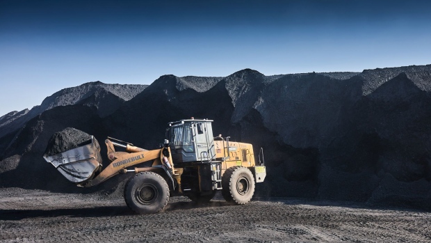 A wheel loader transports coal from a pile at the Mafube open-cast coal mine, operated by Exxaro Resources Ltd. and Thungela Resources Ltd., in Mpumalanga, South Africa on Friday, Sept. 9, 2022. South Africa relies on coal to generate more than 80% of its electricity, and has been subjected to intermittent outages since 2008 because state utility Eskom Holdings SOC Ltd. can't meet demand from its old and poorly maintained plants. Photographer: Waldo Swiegers/Bloomberg