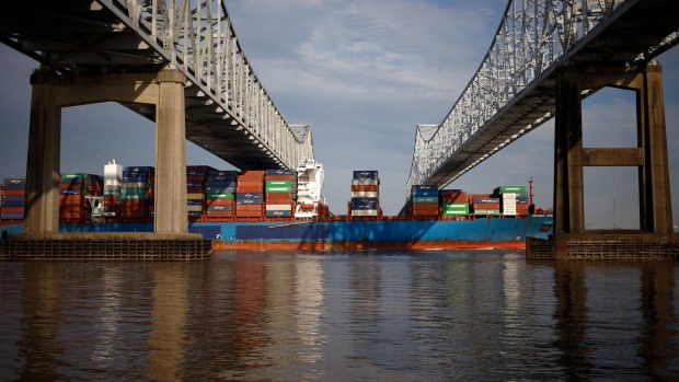 A container ship passes beneath the Crescent City Connection bridge near the Port of New Orleans. Photographer: Luke Sharrett/Bloomberg