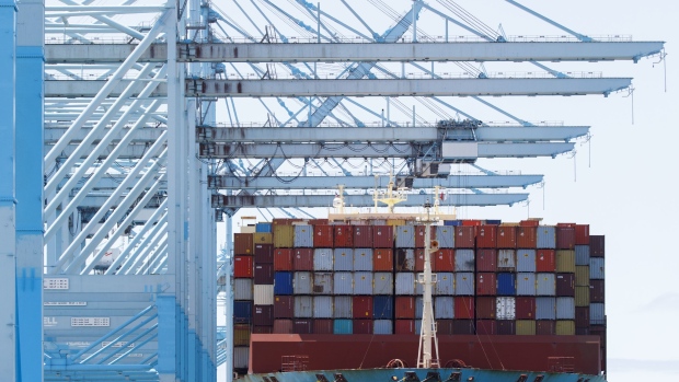 Shipping containers are unloaded from the Maersk Edinburgh cargo ship at the APM shipping terminal in the Port of Los Angeles in Los Angeles, California, U.S., on Tuesday, May 7, 2019. The terminal is planning to replace diesel trucks and human workers. It has already ordered an electric, automated carrier from Finnish manufacturer Kalmar, part of the Cargotec Corp., that can fulfill the functions of three kinds of manned diesel vehicles: a crane, top-loader and truck. Photographer: Patrick T. Fallon/Bloomberg
