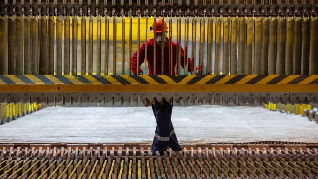 A worker inspects copper cathode and anode sheets in an electrolytic tank in the electrolysis shop at the Uralelectromed Copper Refinery, operated by Ural Mining and Metallurgical Co. (UMMC), in Verkhnyaya Pyshma, Russia, on Thursday, May 20, 2021. A rebound in the world’s largest economies as the vaccination against Covid-19 rolls out is stoking demand for metals, food and energy when supplies are still constrained, creating short-term shortages.