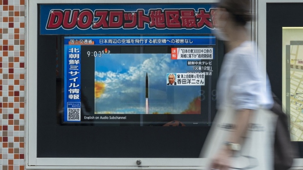 A broadcast showing file footage of North Korean missile launches after the country fired a missile that flew over northeastern Japan, in Tokyo on Oct. 4. Photographer: Richard A. Brooks/AFP/Getty Images
