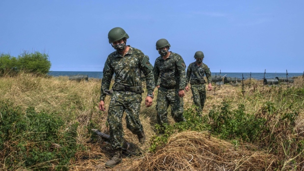 Soldiers walk along a beach during a military exercise in Miaoli, Taiwan, on Tuesday, July 26, 2022. The dispute over Taiwan's sovereignty is the main issue that risks one day leading to war between the US and China, with calls growing among American politicians for a commitment to get involved if Beijing invades the island.