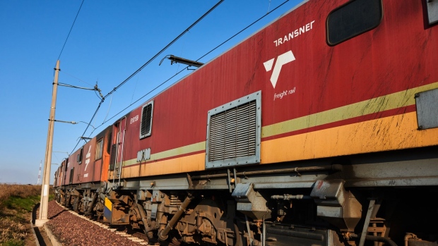 The locomotive of a Transnet SOC Ltd. freight train transports wagons of coal from the Mafube open-cast coal mine, operated by Exxaro Resources Ltd. and Thungela Resources Ltd., towards Richard's Bay coal terminal, in Mpumalanga, South Africa on Thursday, Sept. 29, 2022. South Africa relies on coal to generate more than 80% of its electricity, and has been subjected to intermittent outages since 2008 because state utility Eskom Holdings SOC Ltd. can't meet demand from its old and poorly maintained plants. Photographer: Waldo Swiegers/Bloomberg