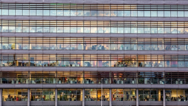Lights illuminate offices at the PricewaterhouseCoopers LLP (PwC) building in Dublin, Ireland, on Thursday, Oct. 15, 2020. Office vacancy rate rose from 6.65% at end of the second quarter to 8.64% at end of the third quarter, CBRE Group Inc. said. Photographer: Patrick Bolger/Bloomberg