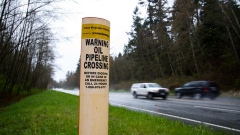 A petroleum pipeline crossing marker stands near the Kinder Morgan facility in Burnaby, British Columbia, Canada, on Wednesday, April 11, 2018. Alberta, the landlocked Canadian province that's home to the oil sands, would be willing to buy out Kinder Morgan's Trans Mountain pipeline if that's the only way to salvage the critical export route, Premier Rachel Notley said.