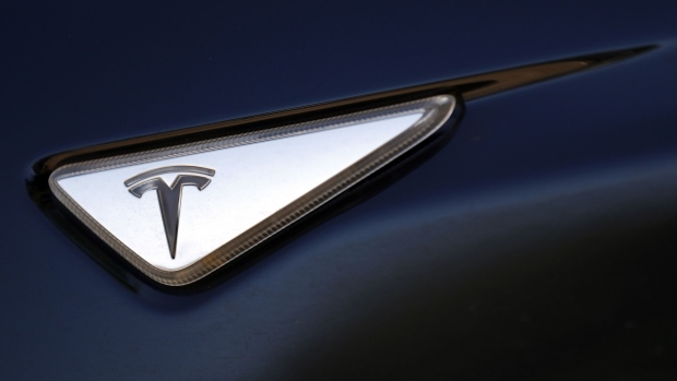 A Tesla logo is displayed on a Tesla Inc. Model S electric vehicle at a Supercharger station in Kriegstetten, Switzerland, on Thursday, Aug. 16, 2018. Tesla chief executive officer Elon Musk has captivated the financial world by blurting out via Twitter his vision of transforming Tesla into a private company.