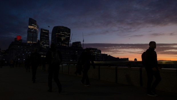 Commuters walk along London Bridge in the City of London, UK, on Monday Oct. 3, 2022. Traders are the most negative ever on the pound’s prospects, even after the UK government scrapped one of its new tax policies, a sign it will take a bigger policy U-turn to restore credibility with markets. Photographer: Carlos Jasso/Bloomberg