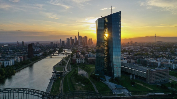 The European Central Bank (ECB) headquarters stands on the bank of the River Main near skyscrapers on the financial district skyline in this aerial photographer at sunset in Frankfurt, Germany, on Tuesday, April 28, 2020. The ECB’s response to the coronavirus has calmed markets while setting it on a path that could test its commitment to the mission to keep prices stable. Photographer: Alex Kraus/Bloomberg