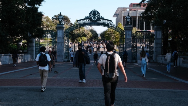Students pass through Sather Gate on the University of California, Berkeley campus in Berkeley, California, US, on Tuesday, Aug. 30, 2022. College students returning to campus this fall will find their dining halls experimenting with everything from fewer salad dressings to "plant-powered" Mondays as schools look for ways to adapt to soaring inflation.