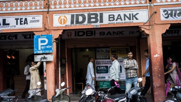 A pedestrian walks past an IDBI Bank Ltd. automated teller machine (ATM) branch in Jaipur, Rajasthan, India, on Wednesday, Oct. 3, 2012. The Indian economy will expand 5.6 percent in the year through March 2013, the weakest pace in a decade, according to forecasts released yesterday by the Asian Development Bank. Photograph: Sanjit Das/Bloomberg