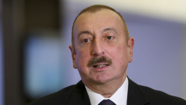 Ilham Aliyev, Azerbaijan's president, speaks to an attendee ahead of the World Economic Forum (WEF) in Davos, Switzerland, on Monday, Jan. 21, 2019. World leaders, influential executives, bankers and policy makers attend the 49th annual meeting of the World Economic Forum in Davos from Jan. 22 - 25.