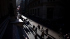 Pedestrians walk along Wall Street near the New York Stock Exchange (NYSE) in New York, U.S., on Monday, Oct. 31, 2016. U.S. stocks rose from a six-week low amid an increase in deal activity as traders assessed the outlook for the presidential election and interest rates in the world's largest economy.