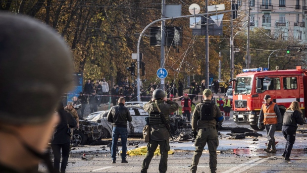 KYIV, UKRAINE - OCTOBER 10: Emergency service personnel attend to the site of a blast on October 10, 2022 in Kyiv, Ukraine. This morning's explosions, which came shortly after 8:00 local time, were the largest such attacks in the capital in months. (Photo by Ed Ram/Getty Images)