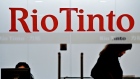 An employee of Australian mining giant Rio Tinto walks past a sign at the company's offices in Shanghai.