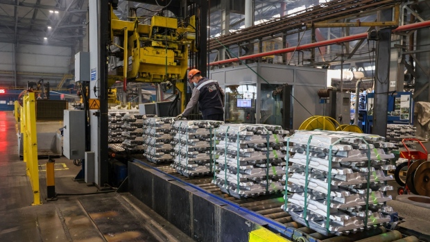 A worker inspects bound stacks of aluminium ingots as they pass along a conveyor belt in the foundry at the Khakas aluminium smelter, operated by United Co. Rusal, in Sayanogorsk, Russia, on Wednesday, May 26, 2021. United Co. Rusal International PJSC’s parent said the company has produced aluminum with the lowest carbon footprint as the race for cleaner sources of the metal intensifies.