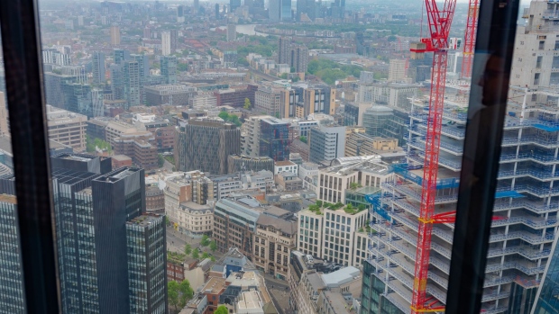 Commercial buildings in the City Of London in front of Canary Wharf, center, viewed from the Leadenhall Building in London, UK, on Tuesday, May 10, 2022. The rise of remote work is a challenge all white-collar industries are wrestling with but poses a particular conundrum in finance given some critical roles — particularly trading — demand a fully-staffed office.