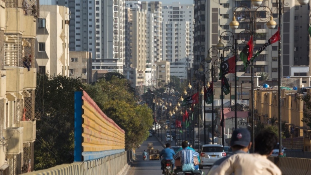 Traffic moves past apartment buildings in the Clifton area of Karachi, Pakistan, on Saturday, March 5, 2022. Pakistan’s central bank will likely keep rates on hold at 9.75% at its March 8 meeting after aggressive tightening in the second half of 2021. Photographer: Asim Hafeez/Bloomberg