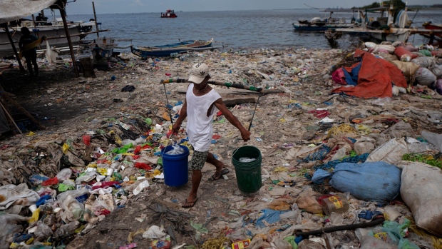 MANILA, PHILIPPINES - APRIL 18: A man carrying fish in a beach filled with plastic wastes coming from the inner city on April 18, 2018 in Manila, Philippines. The Philippines has been ranked third on the list of the world's top-five plastic polluter into the ocean, after China and Indonesia, while reports show that almost half of the global plastic garbage come from developing countries, including Vietnam and Thailand. Sunday marks the 48th iteration of Earth Day, an annual event marked across the world to show support for environmental protection, as organizations aim to dedicate this year's theme towards ending plastic pollution and change people's attitudes and behavior about plastic consumption and the impact it has on the environment. Over a million people have reportedly signed petitions around the world, demanding for corporations to reduce the production of single-use plastics which affects rapidly developing countries as most disposable packaging like food-wrapping, sachets, and shopping bags land up on the coastlines after being discarded. Most of these countries lack the infrastructure to effectively manage their waste and those who live on lower incomes usually rely on cheap products which are sold in single-use sachets such as instant coffee, shampoo, and food seasoning. According to studies, there could be more plastic in the sea than fish by 2050 while actual plastic bits might be in our seafood as fishes consume bits of plastic which are coated in bacteria and algae, mimicking their natural food sources, and eventually lands on our dinner table. (Photo by Jes Aznar/Getty Images)