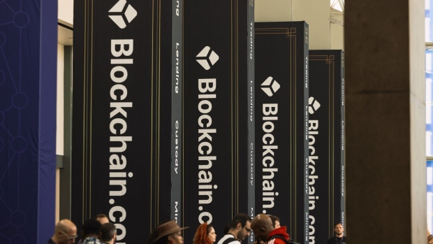 Attendees walk passed advertisements for Blockchain.com during the CoinDesk 2022 Consensus Festival in Austin, Texas, US, on Saturday, June 11, 2022. The festival showcases all sides of the blockchain, crypto, NFT, and Web 3 ecosystems, and their wide-reaching effect on commerce, culture, and communities.