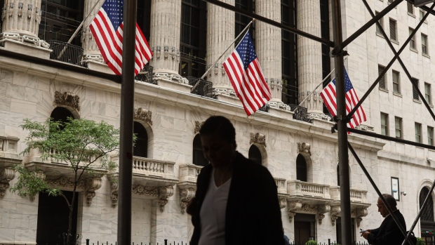 Pedestrians outside the New York Stock Exchange (NYSE) in New York, US, on Monday, July 18, 2022. US stocks fell amid a drop in big tech as investors assessed the outlook for corporate profits and risks to economic growth as central banks hike interest rates to combat runaway inflation.