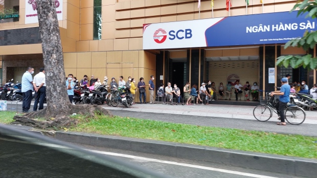 Customers line up in front of a Saigon Commercial Bank branch in Ho Chi Minh City on Oct. 10.