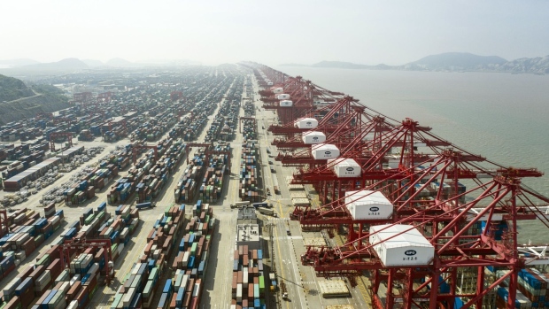 Gantry cranes and containers at the Yangshan Deepwater Port in Shanghai, China, on Tuesday, July 5, 2022. Senior US and Chinese officials discussed US economic sanctions and tariffs Tuesday amid reports the Biden administration is close to rolling back some of the trade levies imposed by former President Donald Trump. Photographer: Qilai Shen/Bloomberg