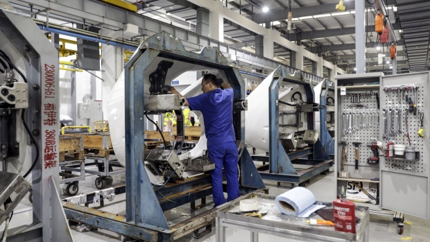 An employee works on the production floor at the Voith Turbo Power Transmission Co. auto parts factory in Shanghai, China, on Thursday, July 21, 2022. Most, if not all, companies in Shanghai have resumed work since June 1, when the city reopened following a brutal two-month lockdown. Photographer: Qilai Shen/Bloomberg