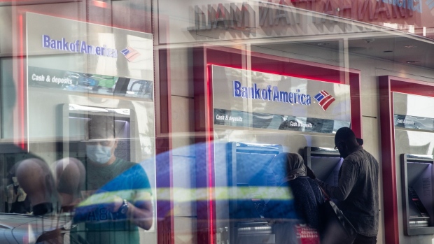 Customers use automated teller machines (ATM) at a Bank of America Corp. branch in New York, U.S., on Thursday, July 9, 2020. Bank of America is scheduled to release earnings figures on July 16. Photographer: Jeenah Moon/Bloomberg