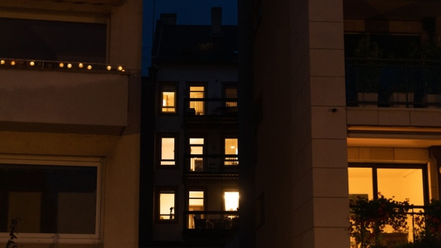 A partially-lit apartment block at night in a residential district of Strasbourg, France. Photographer: Benjamin Girette/Bloomberg