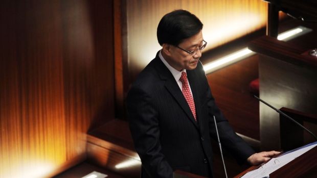 John Lee, Hong Kong's chief executive, delivers his policy address at the Legislative Council in Hong Kong, China, on Wednesday, Oct. 19, 2022. Hong Kong will refund property stamp duty paid by foreigners who subsequently become permanent residents in the city, Lee said. Photographer: Paul Yeung/Bloomberg