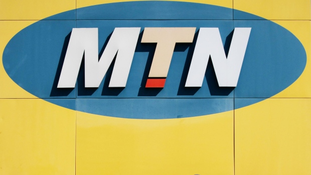 An MTN logo sits illuminated in an MTN Group Ltd. telecommunications store at the Clearwater Mall in Johannesburg, South Africa, on Thursday, Aug. 3. 2017. MTN Group Ltd. said a Nigerian listing that it agreed to as part of a $1 billion regulatory fine was on track and would take place within the next six to 12 months. Photographer: Waldo Swiegers/Bloomberg
