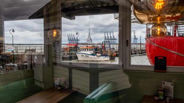 Idle ship-to-shore cranes, seen through the windows of an empty restaurant, on the dockside during the first-day of the second strike action by Unite union members and dockworkers at the Port of Felixstowe, UK, on Tuesday, Sept. 27, 2022. Dock workers at Felixstowe, Britain's largest container port, rejected a pay deal imposed by management, that paved the way for this new round of industrial action and disruption to vital trade flows. Photographer: Chris J. Ratcliffe/Bloomberg