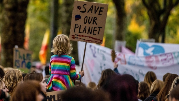 A young climate activist holding a placard reading "Save our planet" during a protest march on the "Youth Day" at the COP26 climate talks in Glasgow, UK, on Nov. 5, 2021. 
