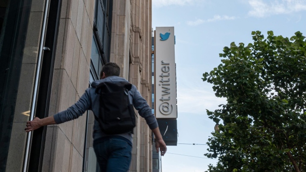A pedestrian outside Twitter headquarters in San Francisco, California, US, on Thursday, Oct. 6, 2022. Stock markets are still not entirely sold on Elon Musk's $44 billion takeover of Twitter Inc. after the billionaire revived the deal at its original price earlier this week.