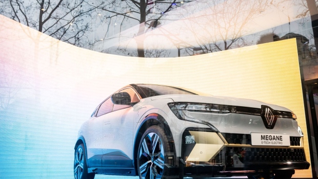 A Renault SA Megane E-tech electric vehicle (EV) in a window at the L'Atelier Renault flagship store on the Champs Elysees in Paris, France, on Wednesday, Feb. 16, 2022. Renault is scheduled to report results for 2021 on Feb. 18. Photographer: Benjamin Girette/Bloomberg