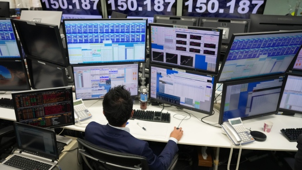 A dealer works near monitors showing the rate of the yen against the US dollar in the trading room at foreign exchange brokerage Gaitame.Com Co. in Tokyo, Japan, on Friday, Oct. 21, 2022. The yen’s slump past the symbolic mark of 150 per dollar is keeping traders guessing when Japanese authorities will intervene to halt a further decline. Photographer: Toru Hanai/Bloomberg