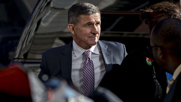 Michael Flynn, former U.S. national security adviser, center, arrives at federal court in Washington, D.C., U.S., on Tuesday, Dec. 18, 2018. President Donald Trump offered public well wishes to Flynn, hours before his former national security adviser is set to be sentenced for lying to investigators about his contacts during the 2016 campaign with the Russian ambassador.