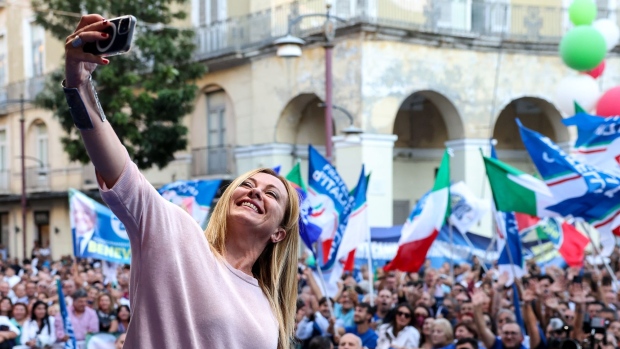 Giorgia Meloni, leader of the Brothers of Italy party, takes a selfie at the end of an election campaign rally in Caserta, Italy, on Sunday, Sept. 18, 2022. Italy's right-wing coalition, led by Giorgia Meloni's Brothers of Italy, is poised for a landslide win on Sept. 25, according to the last available polls before a blackout period.