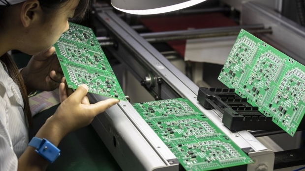 An employee inspects integrated circuit boards at the Smart Pioneer Electronics Co. factory in Suzhou, China, on Friday, Sept. 23, 2022. In a world where chips are becoming smarter and smaller, they require much less advanced technology to manufacture and therefore command smaller margins. Photographer: Qilai Shen/Bloomberg