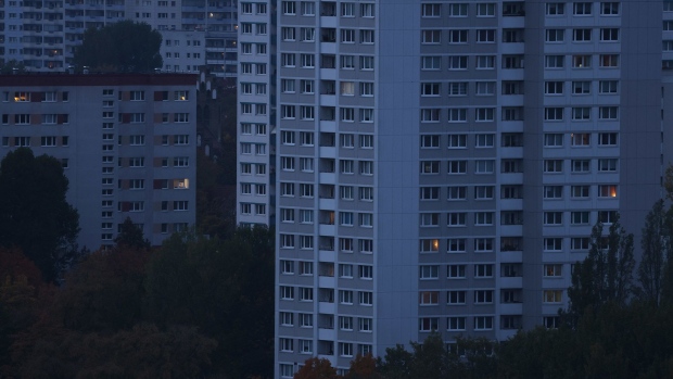BERLIN, GERMANY - OCTOBER 13: Lights glow in apartments in residential buildings at twilight in Marzahn district in the eastern part of the city on October 13, 2022 in Berlin, Germany. The German government is considering a partial price cap on natural gas prices for consumers and industry. For consumers the price would be set at 12 cents per kilowatt hour for the first 80% of the previous year's consumption amount and to begin in March, 2023. In addition the government would reimburse consumers for their December, 2022, natural gas bill. (Photo by Sean Gallup/Getty Images)