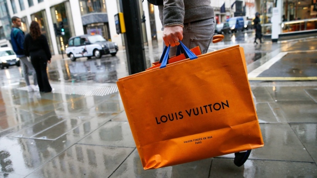 A pedestrian carries a Louis Vuitton shopping bag, from a store operated by LVMH Moet Hennessy Louis Vuitton SE, on New Bond Street in London, U.K., on Wednesday, Oct. 21, 2020. Prices rose 0.5% in September, from 0.2% a month earlier, the Office for National Statistics said Wednesday.