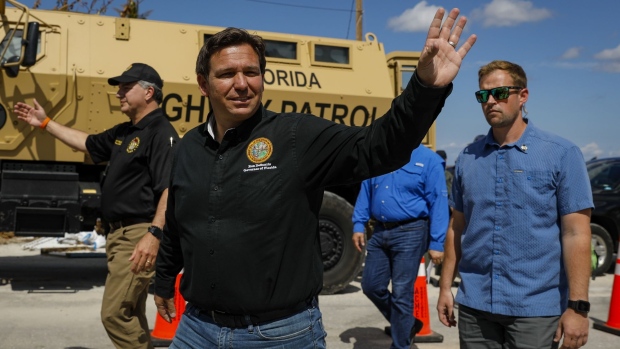 Ron DeSantis, governor of Florida, waves as he arrives to a news conference in Matlacha, Florida, US, on Wednesday, Oct. 5, 2022. DeSantis and President Biden have feuded over political issues, including migrants, but are coordinating on assistance for Floridians hit by a hurricane Biden's called "among the worst in the nation's history."