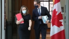 Chrystia Freeland and Tiff Macklem arrive at a news conference in Ottawa on Dec. 13, 2021.