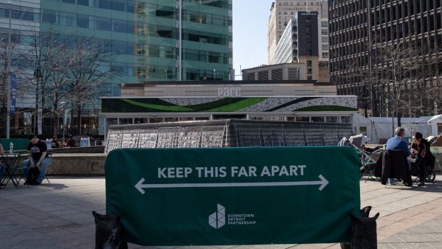 A social distancing sign in Campus Martius in Detroit, Michigan, U.S., on Sunday, March 21, 2021. After seeing declines in Covid-19 case numbers and hospitalizations in January and February, Michigan's coronavirus curve is rocketing skyward yet again as restrictions have relaxed, the Detroit Free Press reports.
