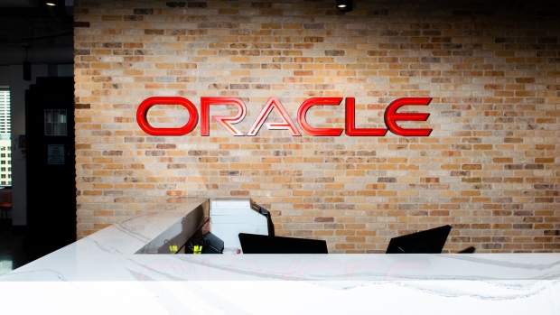 Signage is displayed above the front desk at the cloud infrastructure department of an Oracle Corp. office in Seattle, Washington, U.S., on Thursday, July 19, 2018. Microsoft Corp. and Oracle Corp. announced a cloud interoperability partnership enabling customers to migrate and run mission-critical enterprise workloads across Microsoft Azure and Oracle Cloud. Photographer: Chona Kasinger/Bloomberg