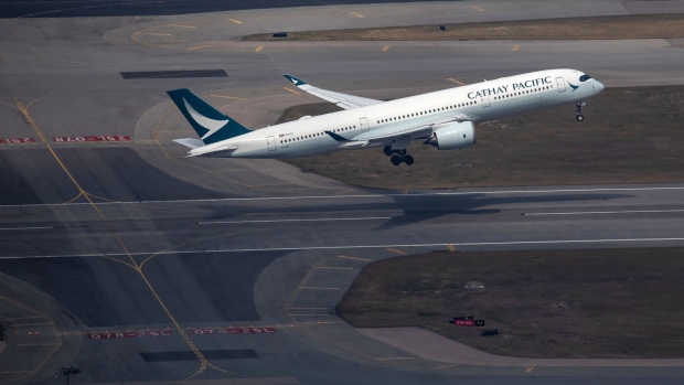 An aircraft operated by Cathay Pacific Airways Ltd. takes off from Hong Kong International Airport in Hong Kong, China, on Thursday, Jan. 6, 2022. Hong Kong is imposing strict new virus control measures for the first time in almost a year as the highly transmissible omicron variant seeps into the community and threatens to spur a winter wave.