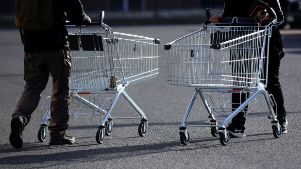 Customers push empty shopping carts outside a Lidl Stiftung & Co. KG supermarket in Berlin, Germany, on Tuesday, Oct. 4, 2022. German inflation for August reached double digits for the first time since the euro was introduced more than 20 years ago, surging more than anticipated after temporary government-relief measures ended and Europe's energy crisis worsened. Photographer: Krisztian Bocsi/Bloomberg